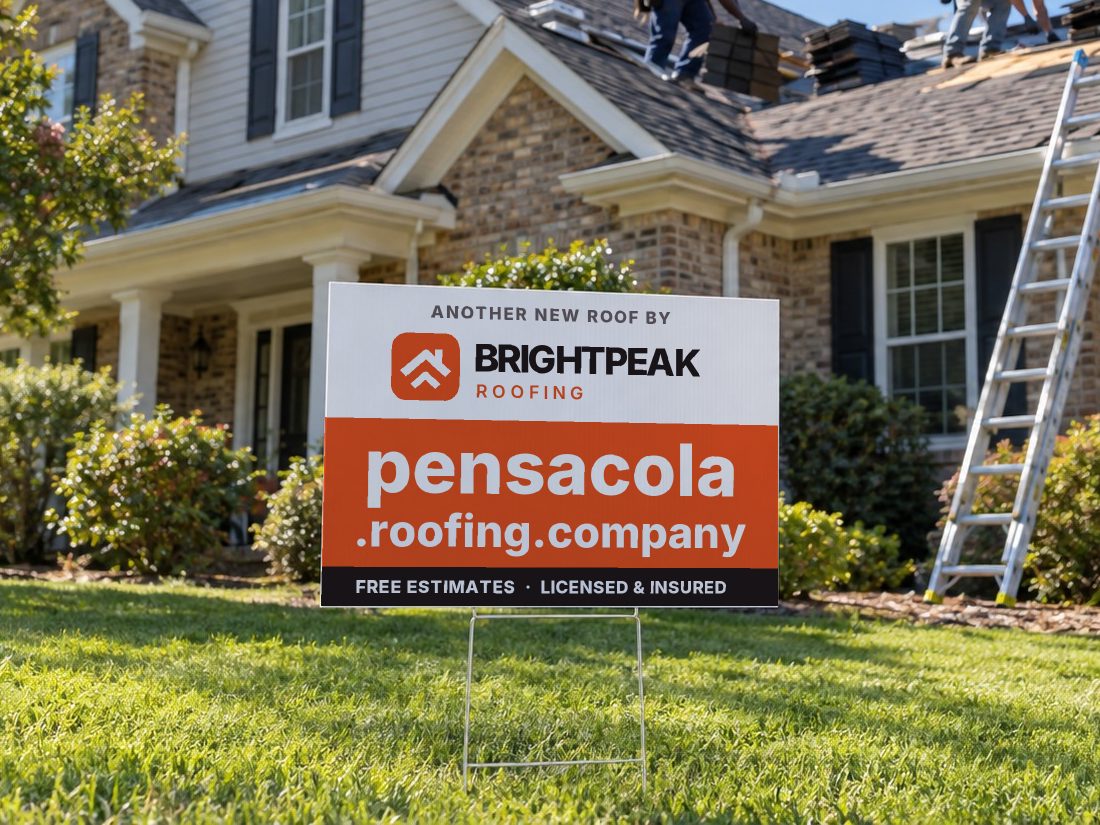 pensacola.roofing.company on a yard sign in front of a house getting a new roof